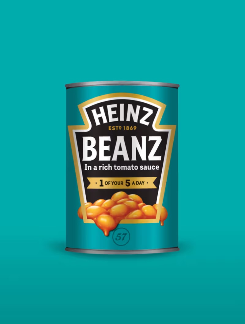 A blue can of Heinz Beanz "in a rich tomato sauce" with baked beans on the label, against a blue-green background.