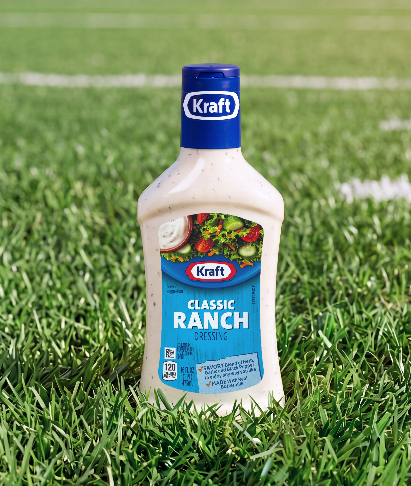 A bottle of Kraft Classic Ranch Dressing standing in green grass on a sports field.