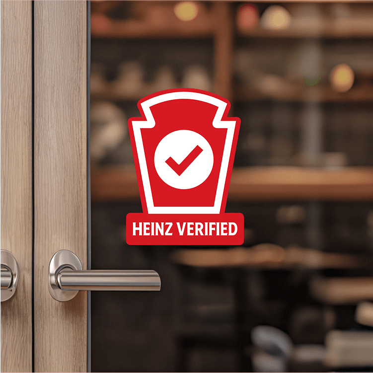 The Heinz Verified logo on a restaurant door, signifying quality and authenticity.
