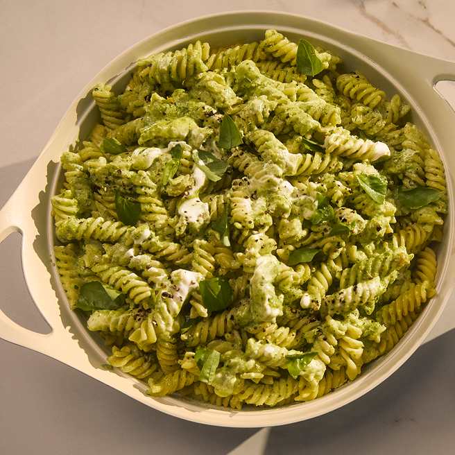 A dish of pasta with a green sauce and Philadelphia Cheese
