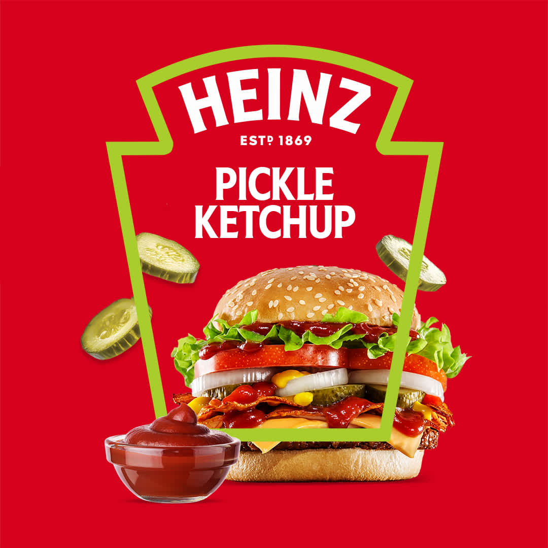 Heinz Pickle Ketchup graphic with a loaded burger, dipping bowl, and floating pickle slices inside a green keystone frame.