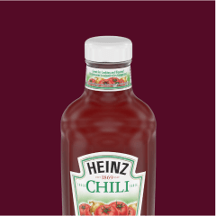 A bottle of Heinz Chili Sauce against a dark background.