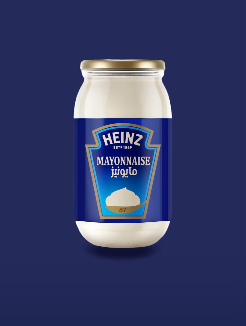 مرطبان مايونيز هاينز مع ملصق أزرق يظهر ملعقة مايونيز، على خلفية زرقاء داكنة.