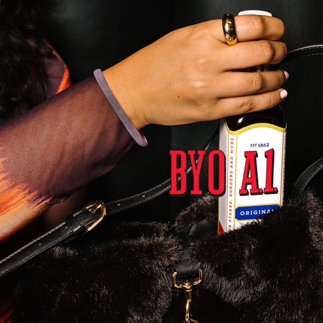Woman carrying a bottle of A1 sauce in a purse.