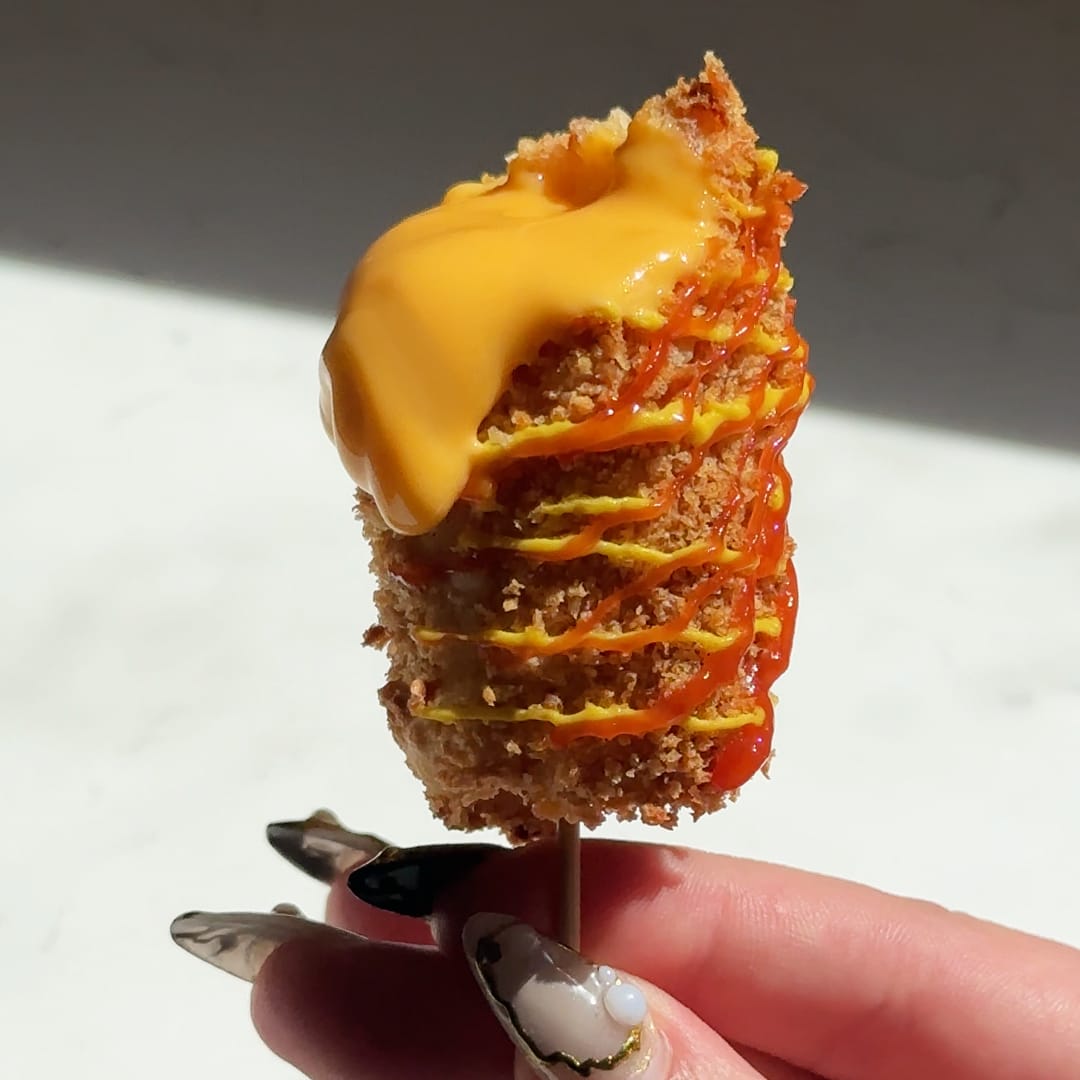 Air Fried Korean Style Corn Dog with Velveeta cheese, mustard, and ketchup drizzle.