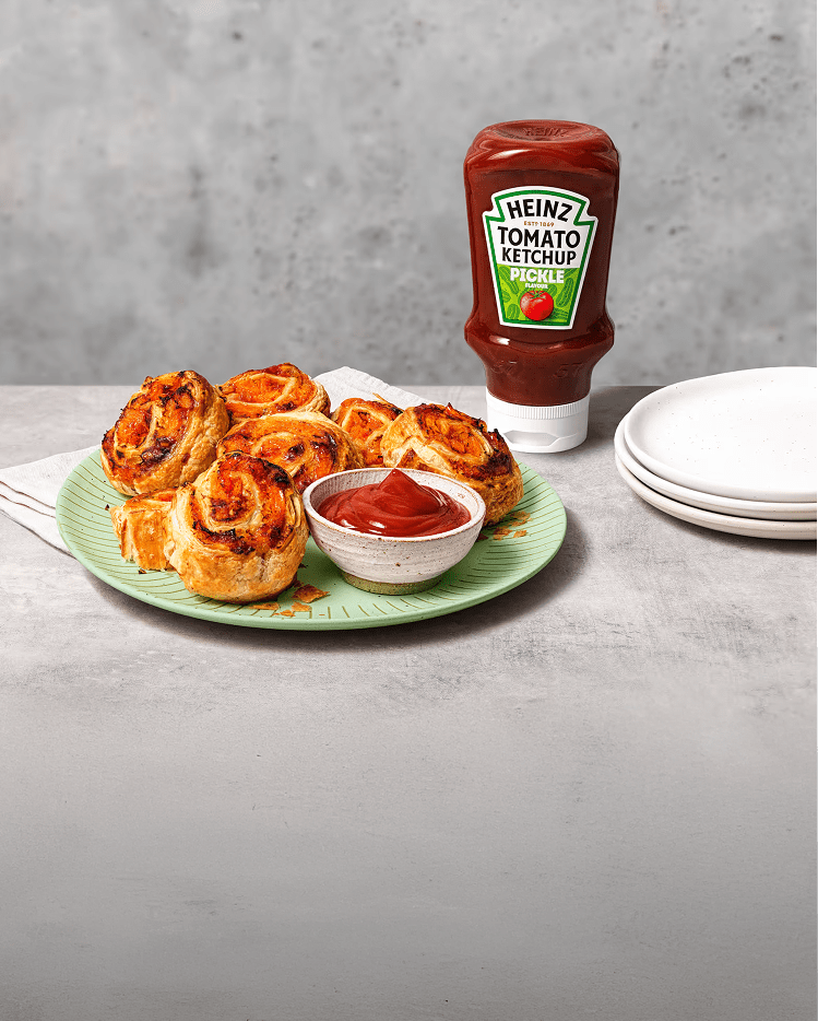 Golden-brown puff pastry swirls served with a side dipping bowl of Heinz Tomato Ketchup with Pickle.