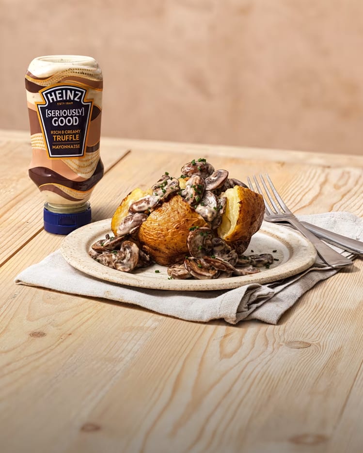 A baked potato overflowing with a creamy mushroom sauté, paired with Heinz Seriously Good Truffle Mayonnaise.