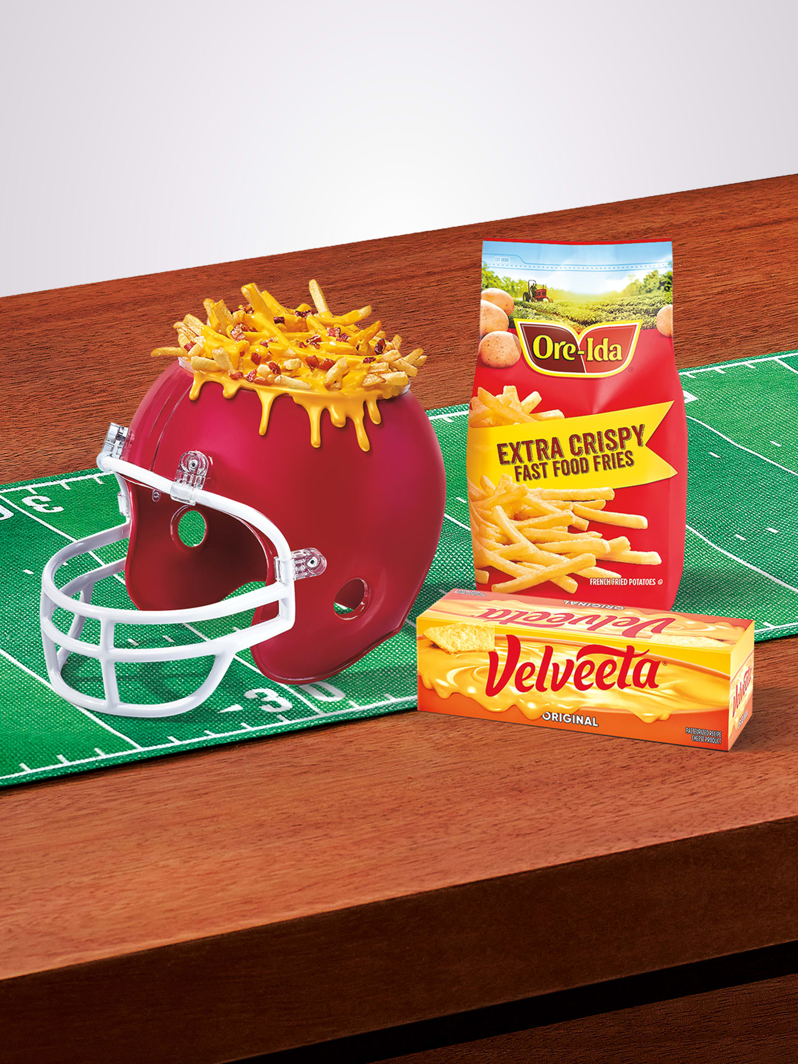 Loaded fries with Ore-Ida, Velveeta, Heinz ketchup & mustard, on a football field.