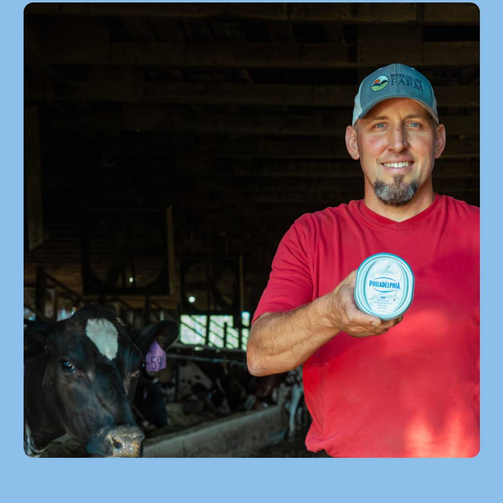 A farmer holding a tub of Philadelphia Cream Cheese Spread
