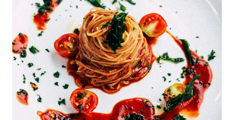 Pasta with tomato sauce and basil leaves
