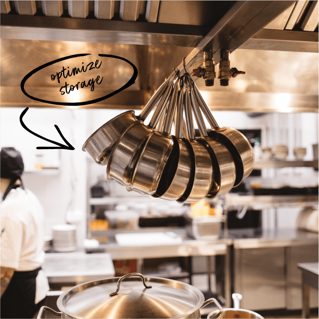 Pots hanging for optimized storage in a commercial kitchen.