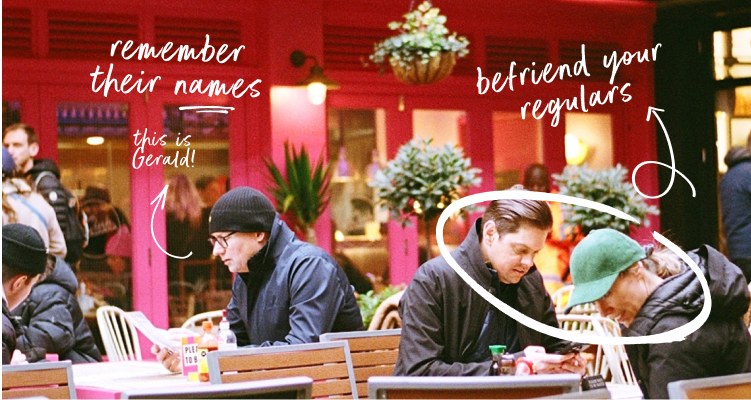 A photo of a group of people sitting at an outdoor table.