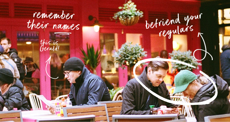 Customers sitting at restaurant tables outside