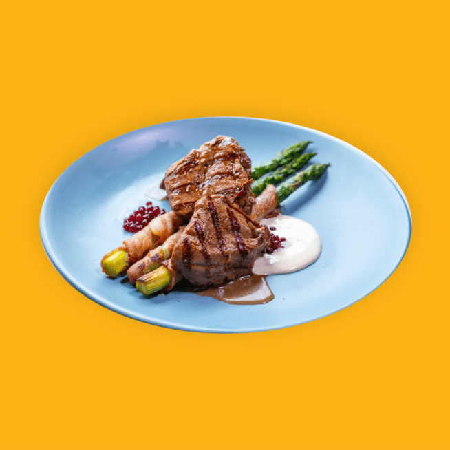 Steak with asparagus and sauce on a plate