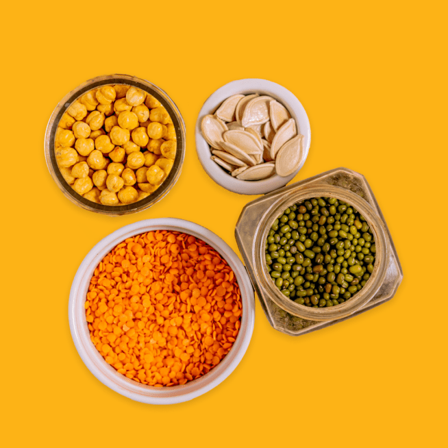 Containers with chickpeas, beans, lentils and pumpkin seeds