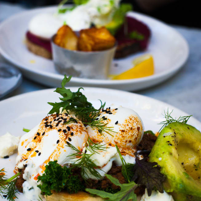 Plate with poached eggs, salad and avocado