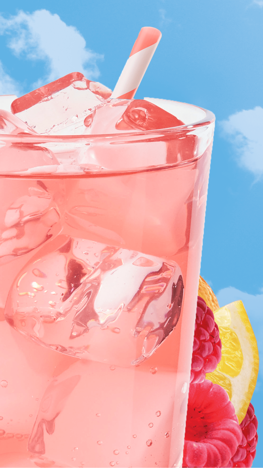 Refreshing pink drink with ice, raspberries, and lemons against a sky backdrop.