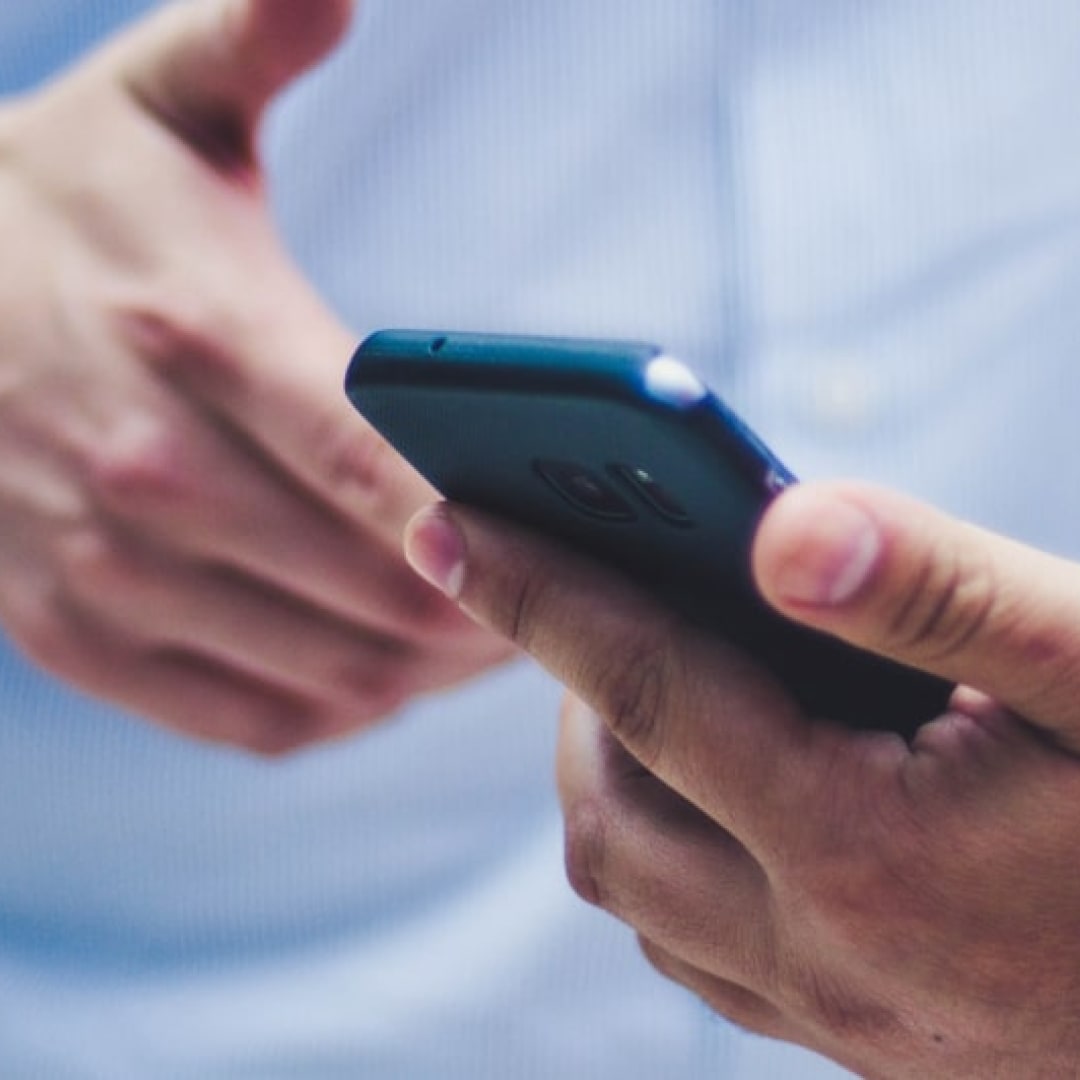 Hand holding a smartphone.