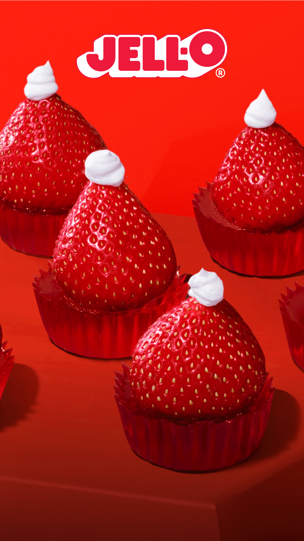 Jell-O tarts topped with strawberries and hint of whipped cream