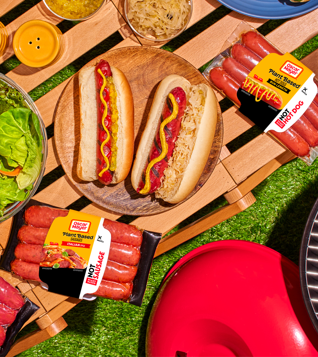 Image of plant-based hot dogs with toppings and Oscar Mayer packaging.