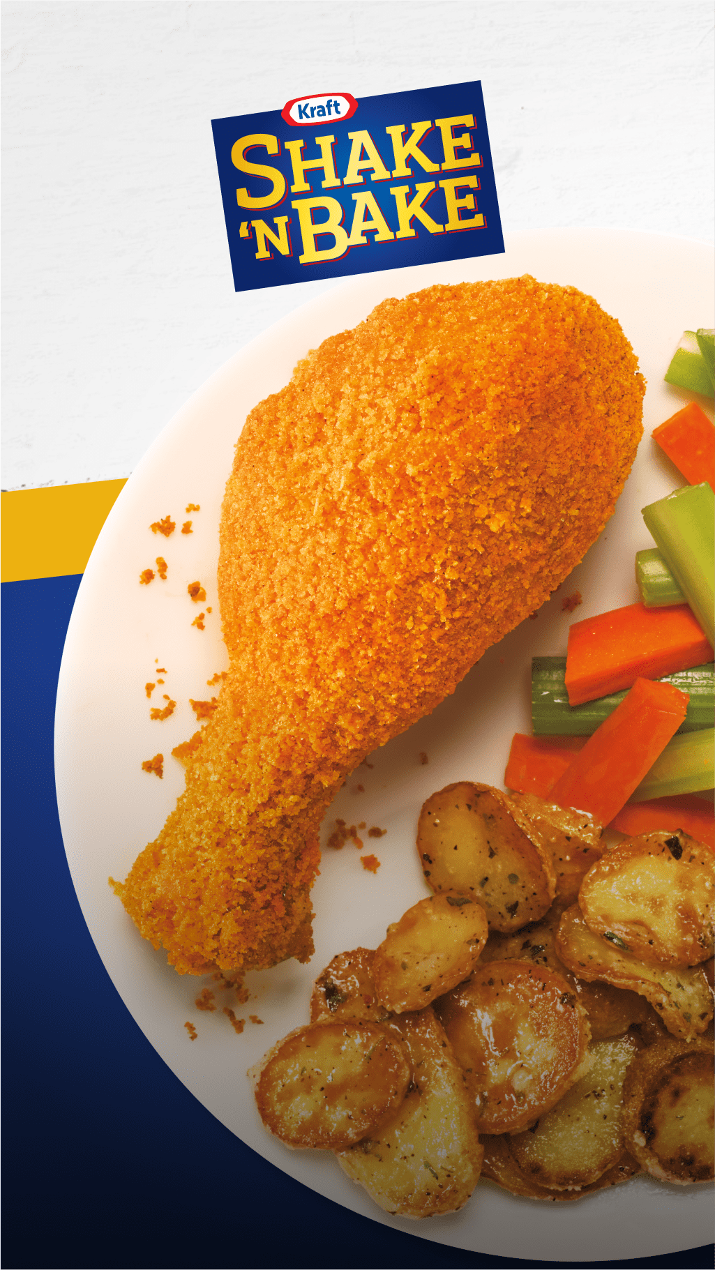 A coated chicken leg on a white plate with veggies and the Shake 'n Bake logo above
