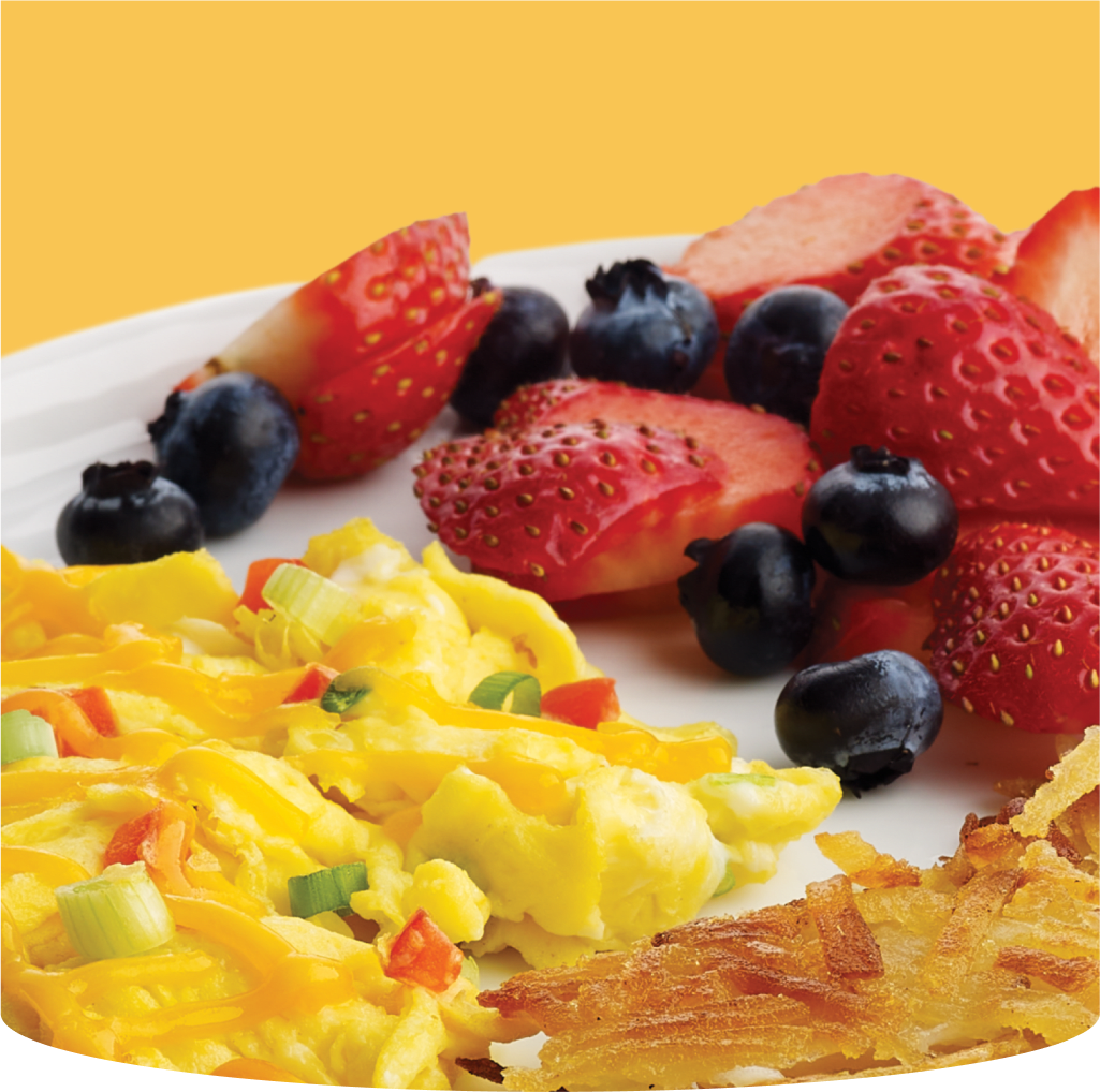 Image of breakfast with eggs, hash browns and berries.