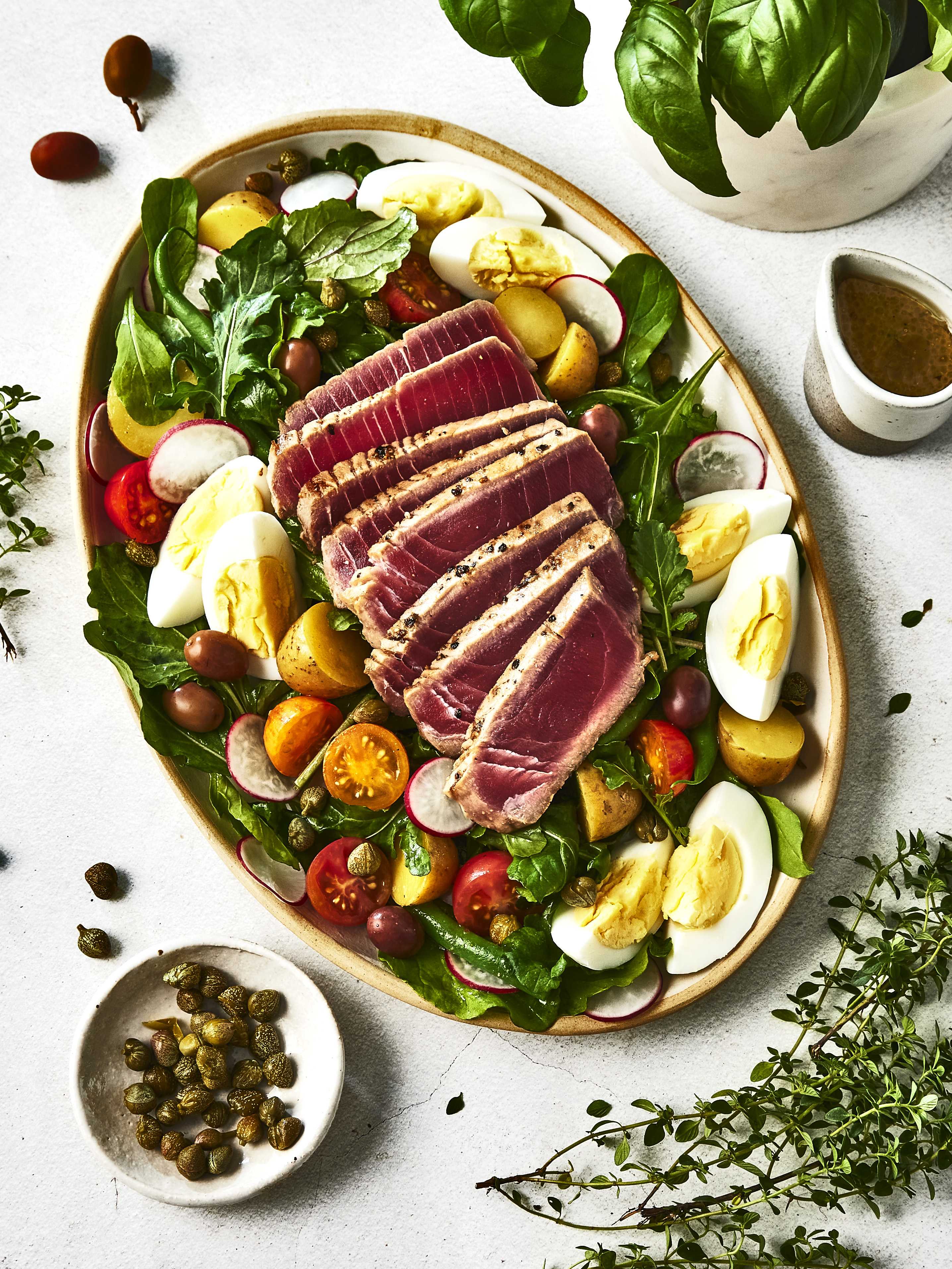 A plate filled with delicious Niçoise Salad made with the line of Pure by J.L. Kraft salad dressings.