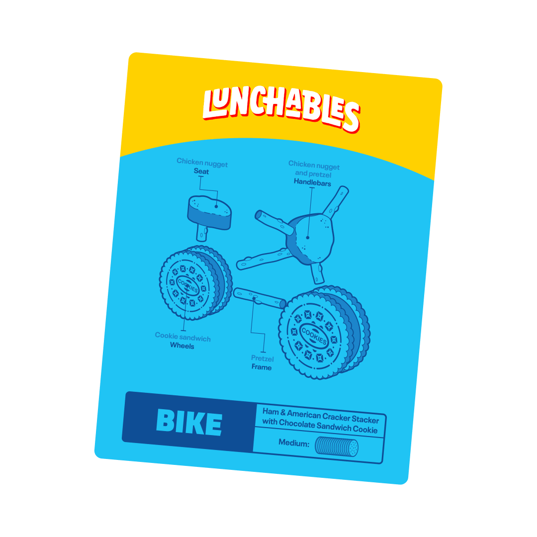 Lunchables bike made of cookie wheels, pretzel frame, & chicken nugget seat/handlebars.