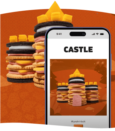 A castle made of stacked cookies, crackers, cheese, and meat.