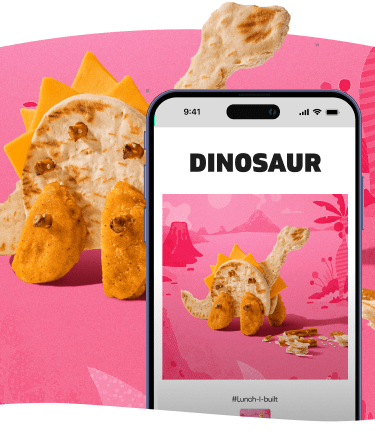 Dinosaur made of pita, cheese, and nuggets next to a phone displaying the same image.