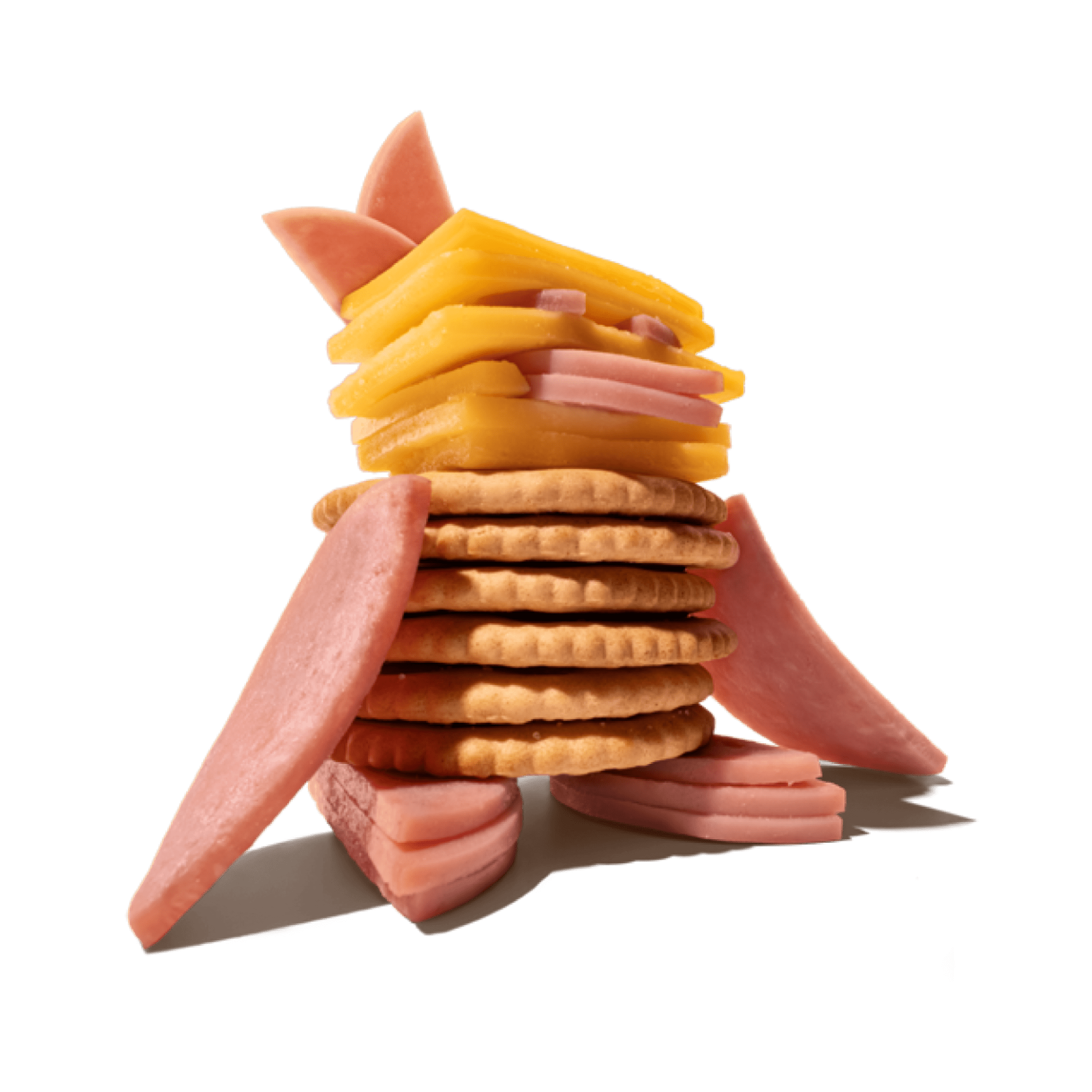 Stack of crackers, cheese, and ham slices.