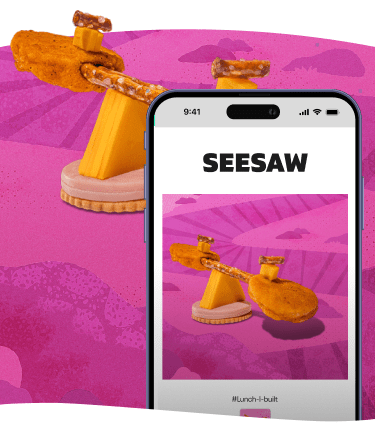 Seesaw made of snack foods: crackers, cheese, pretzels, and mini pancakes.