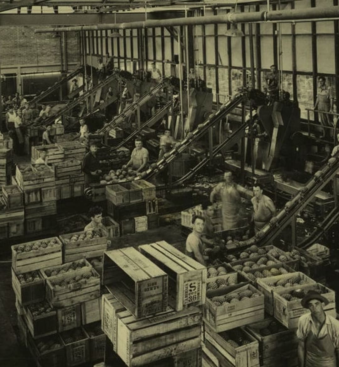A black and white historical photo of a juice factory.