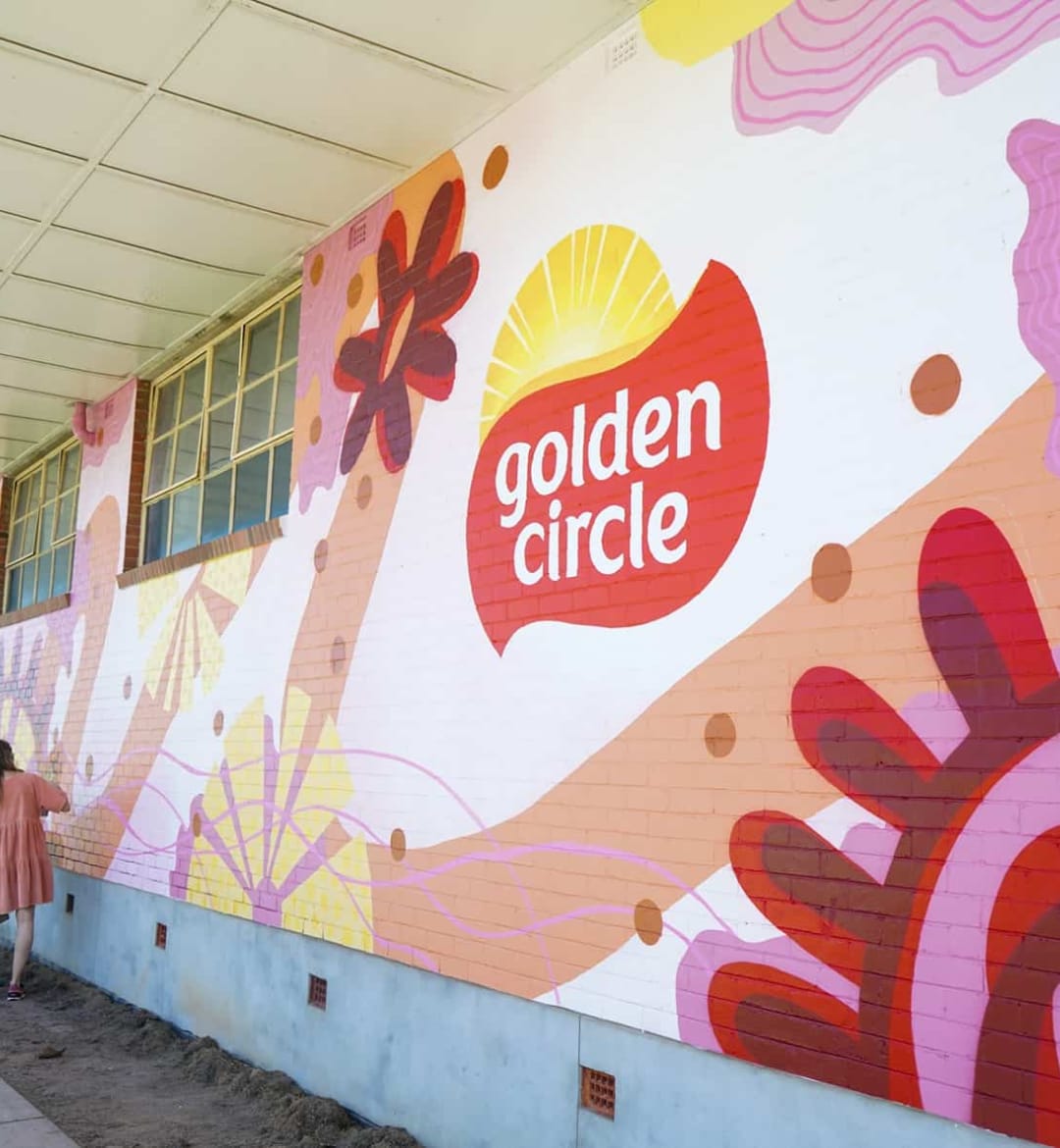 A wall mural featuring the Golden Circle logo.