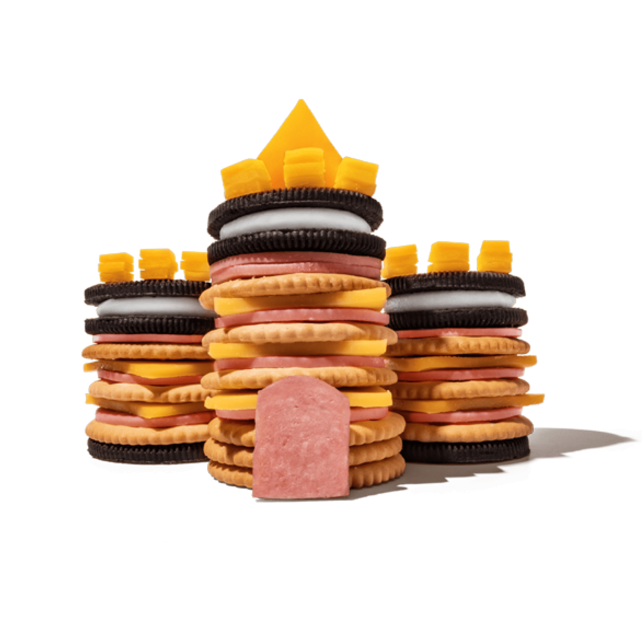 A castle made of cookies, crackers, cheese, and meat.