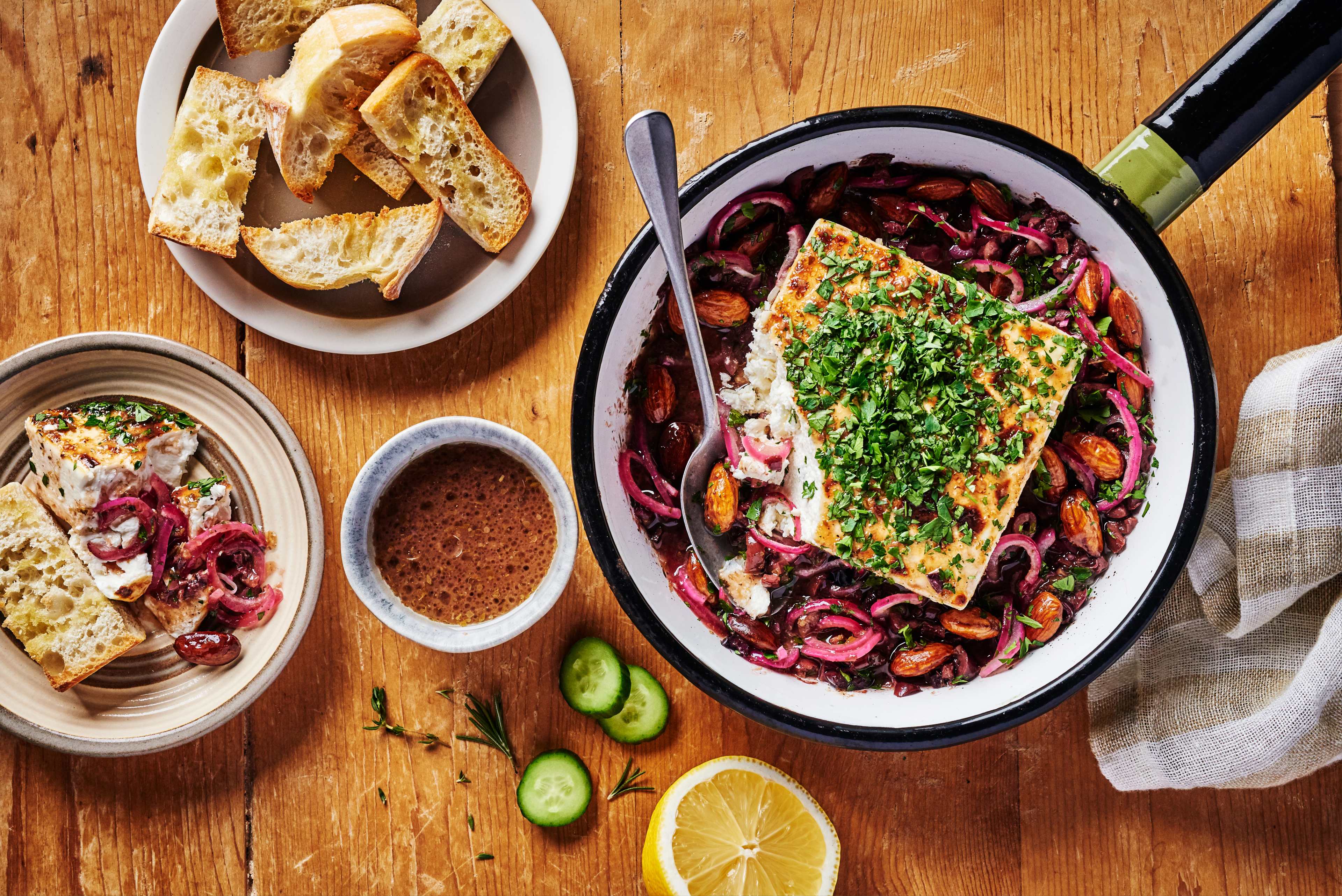 Grilled feta cheese with cucumber, red onion, almonds, kalamata olives, and parsley, made with Pure J.L. KRAFT Cucumber Greek Dressing & Marinade and served with toasted ciabatta slices.