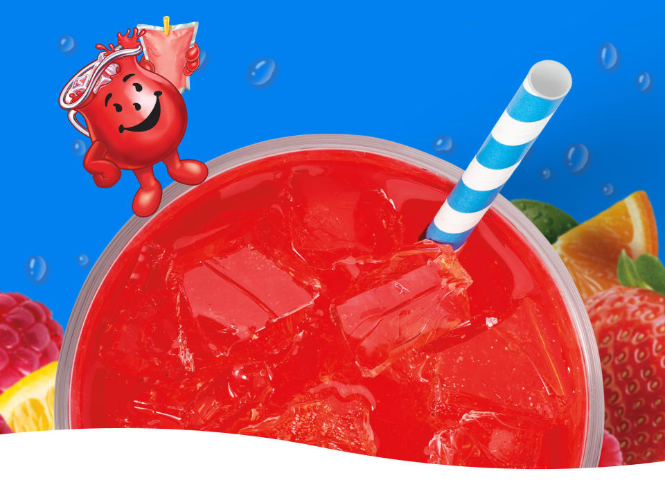 Kool-Aid Man character next to a clear cup of red Kool-Aid with ice, a striped straw, raspberries, and strawberries.