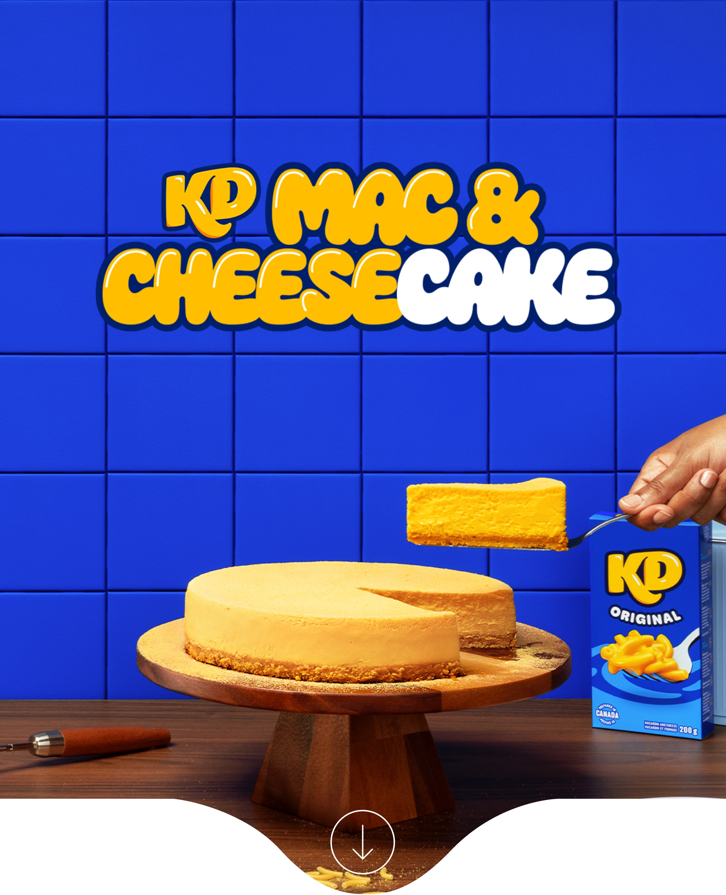 KDessert Mac & Cheesecake advertisement featuring an orange cheesecake, a whisk, and a Kraft Dinner box.