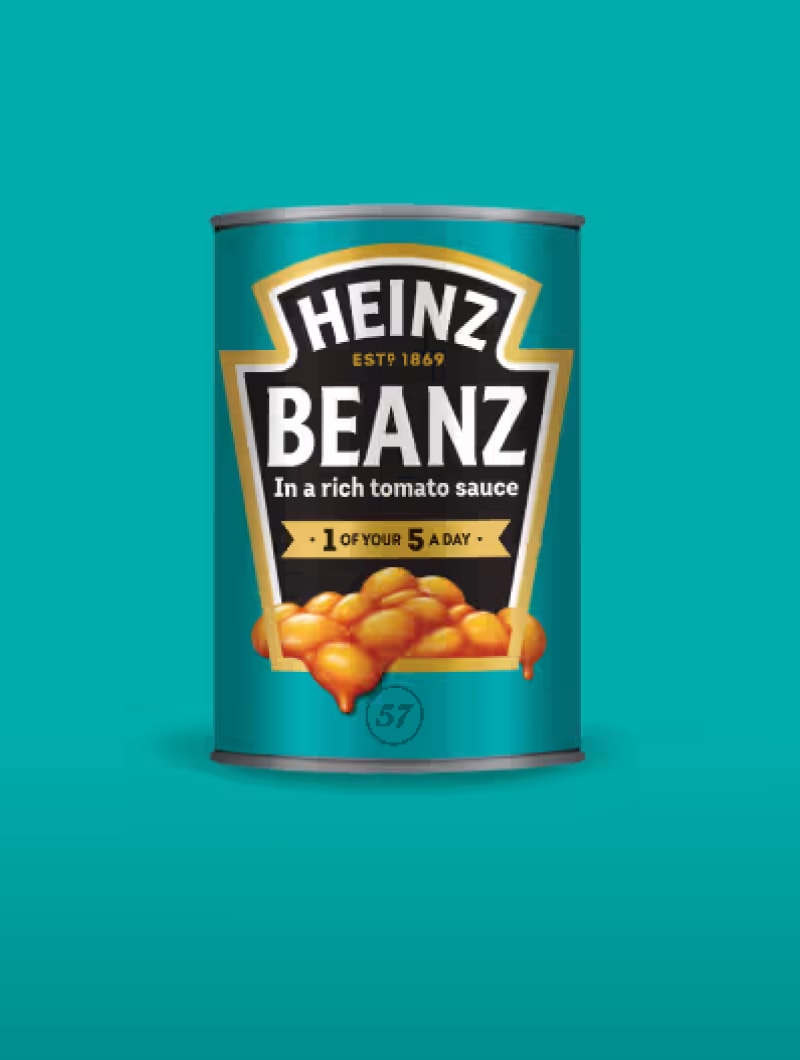 A can of Heinz Beanz, with the label prominently displaying "HEINZ ESTD 1869 BEANZ In a rich tomato sauce - 1 OF YOUR 5 A DAY