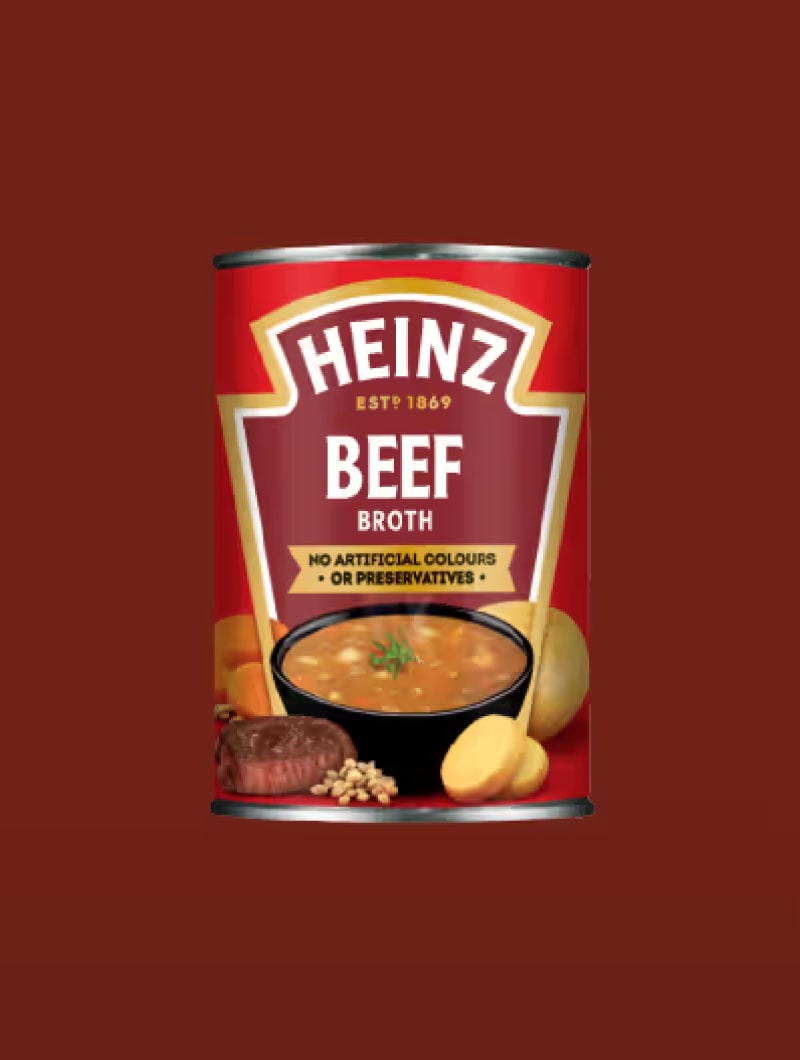 A can of Heinz Beef Broth. The label shows the Heinz keystone logo with "HEINZ ESTD 1869 BEEF BROTH NO ARTIFICIAL COLOURS OR 