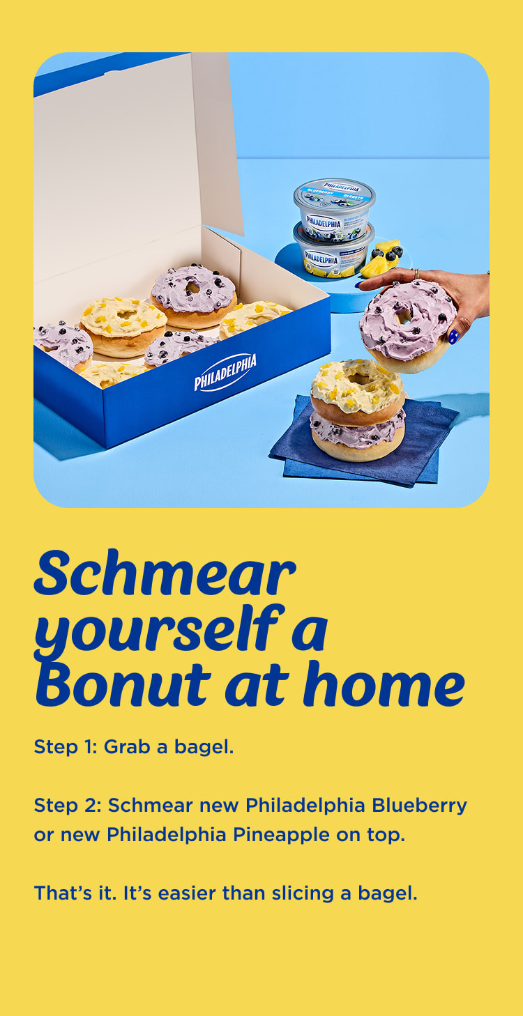 A box of Philadelphia Bonuts, featuring bagels topped with Philadelphia Blueberry and Pineapple Cream Cheese, accompanied by 