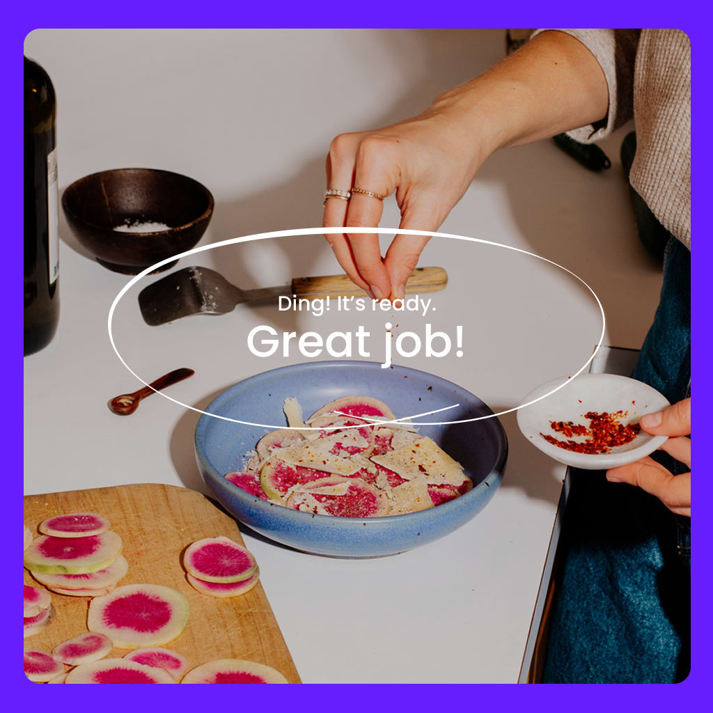 A person sprinkles seasoning on a bowl of radish salad.