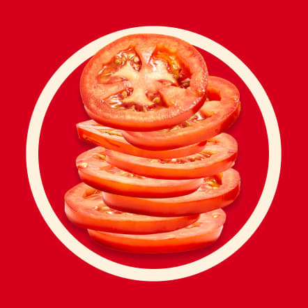 Eight thin slices of ripe, red tomato are stacked slightly offset, creating a visually appealing arrangement against a vibrant red background within a contrasting off-white circle. The juicy flesh and seeds of the tomato slices are clearly visible. This image represents eight servings.