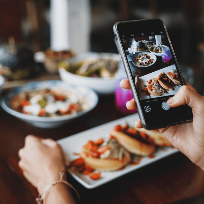Person taking a shot of food on their mobile phone