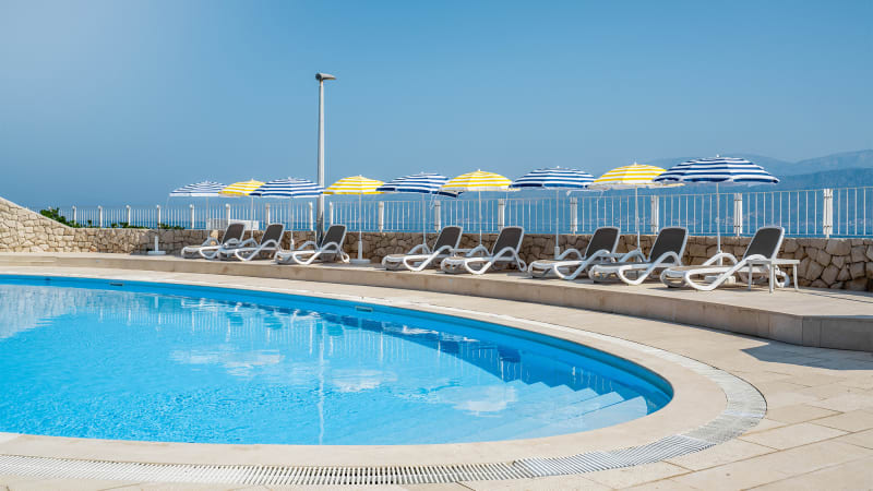 Poolomrde fr charter Kroatien med solstolar och lugn atmosfr