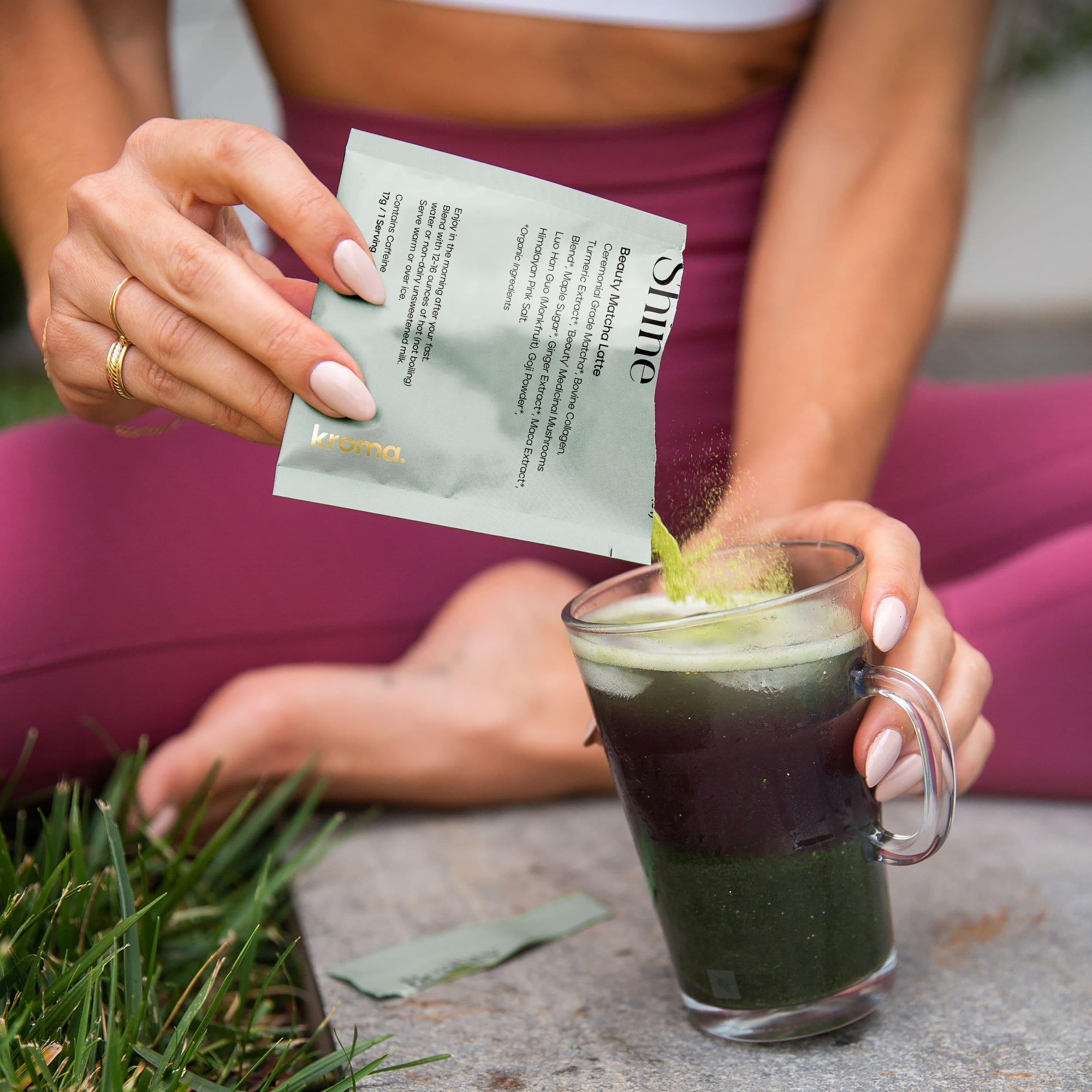 A woman preparing a glass of Kroma Beauty Matcha Latte.