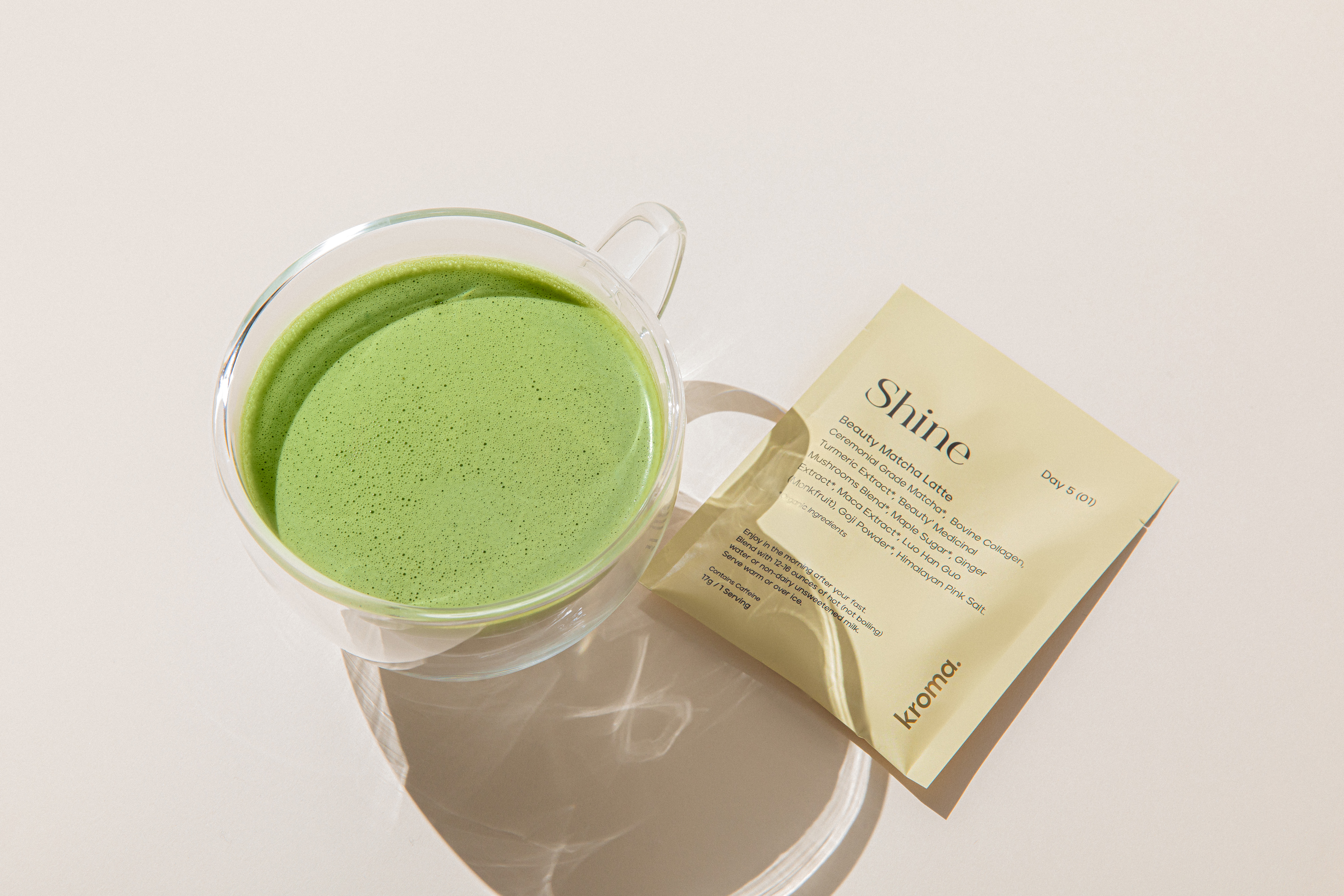 A mug of Kroma Beauty Matcha Latte with sachet.
