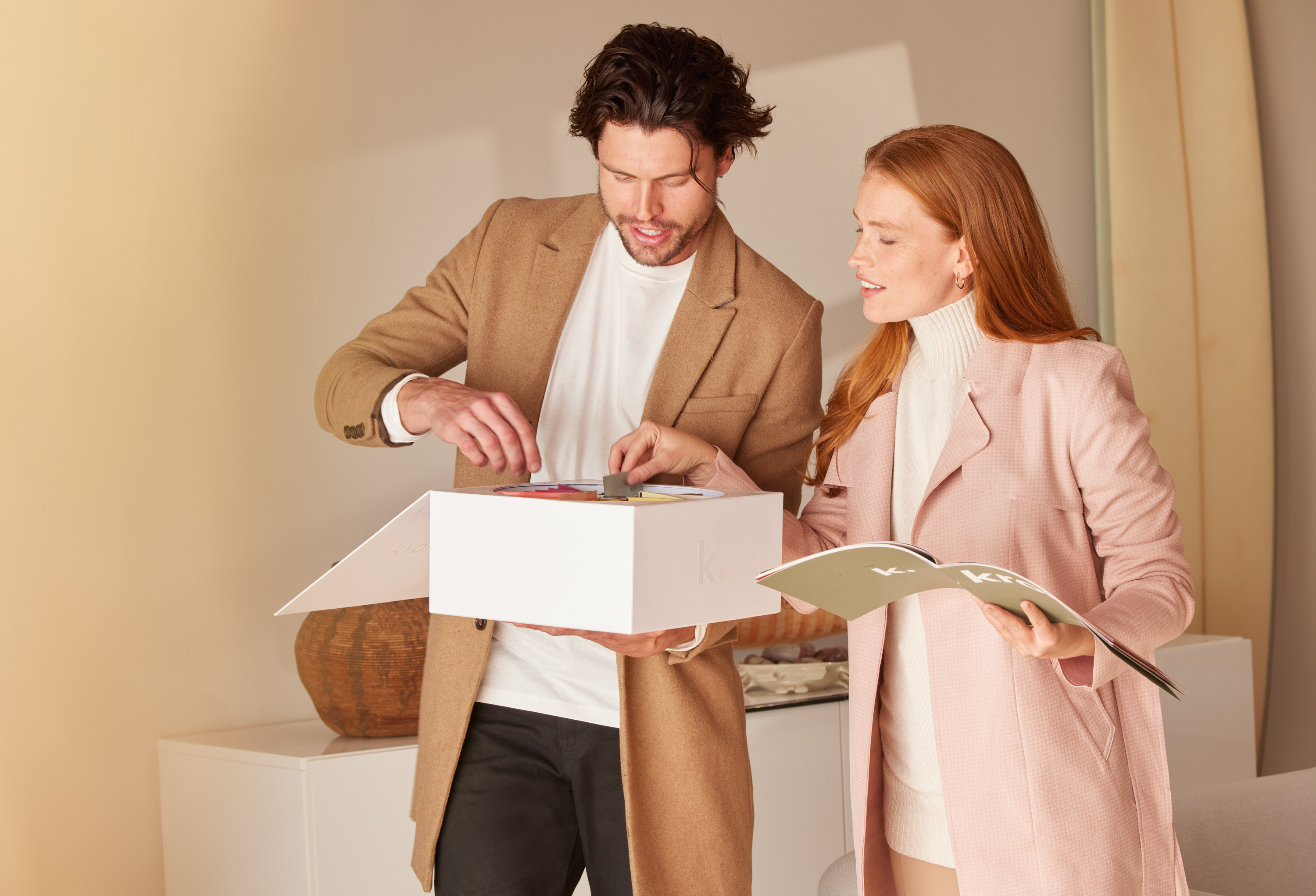 A woman and man examining the contents of a Kroma Signature 5-Day Reset.