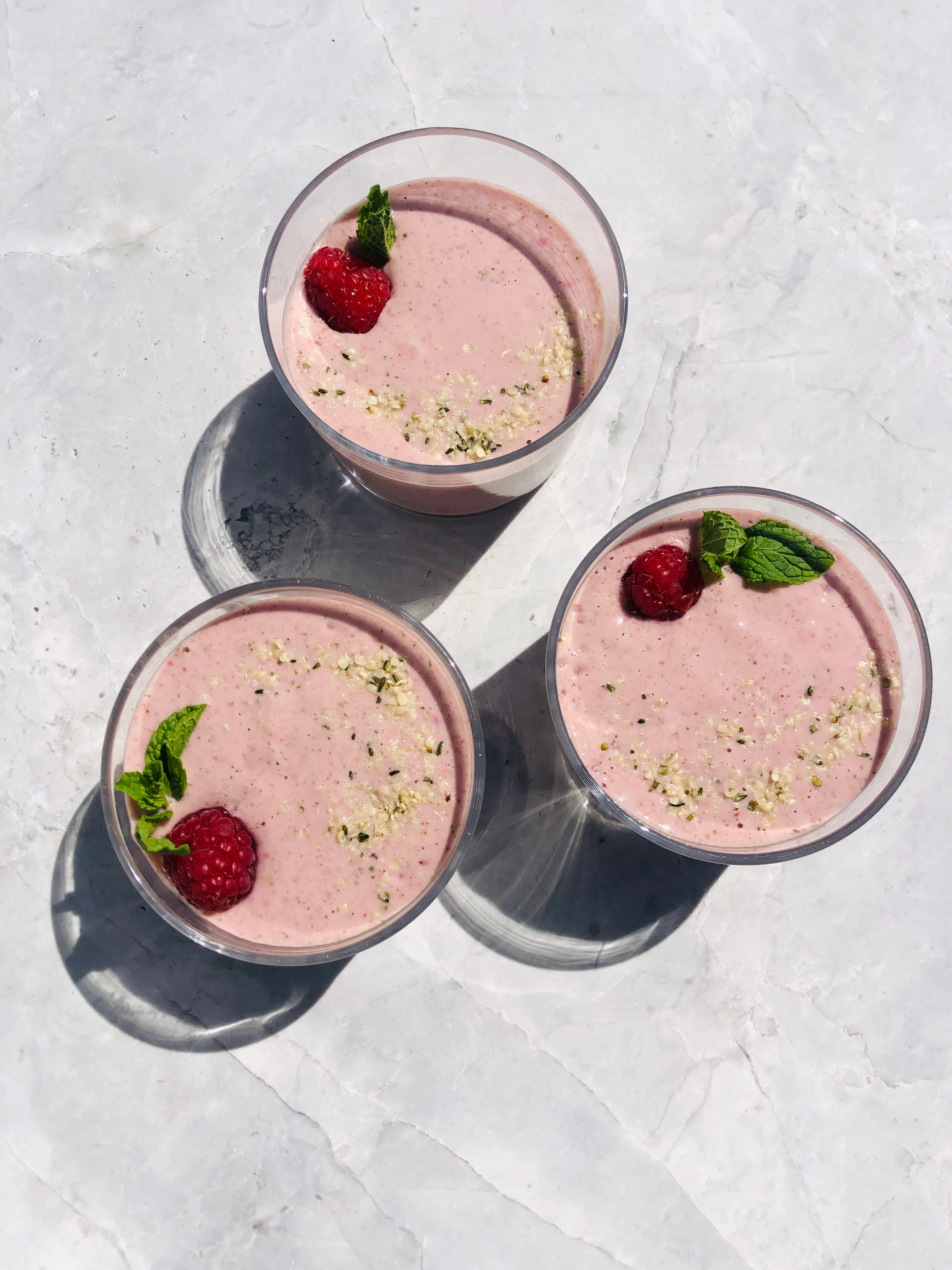 Two glasses of Kroma Razzzberry Mint Smoothies.