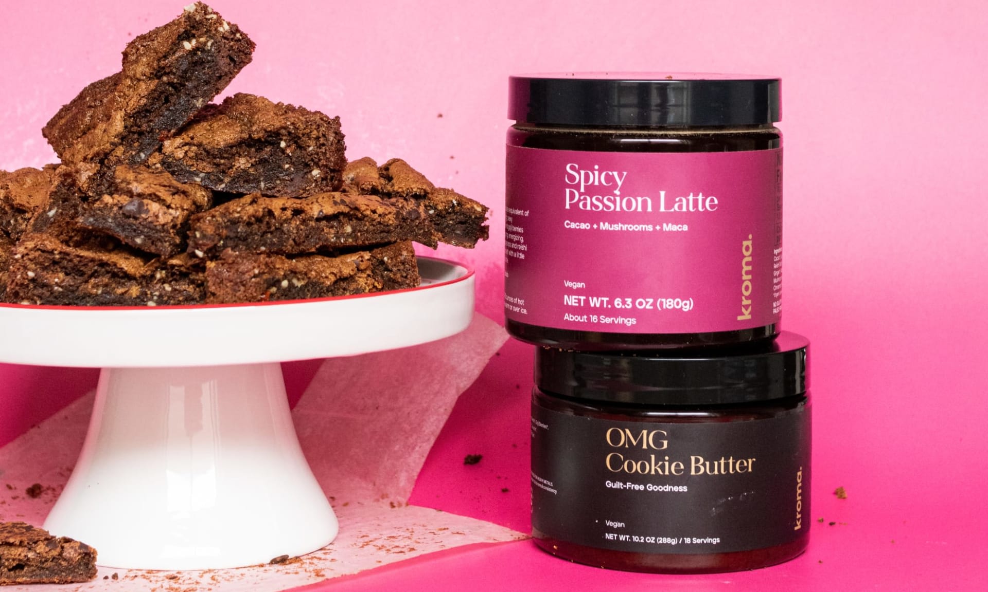 A plate of Kroma Spicy Passion Latte Blondies next to a jar of Spicy Passion and OMG Cookie Butter.